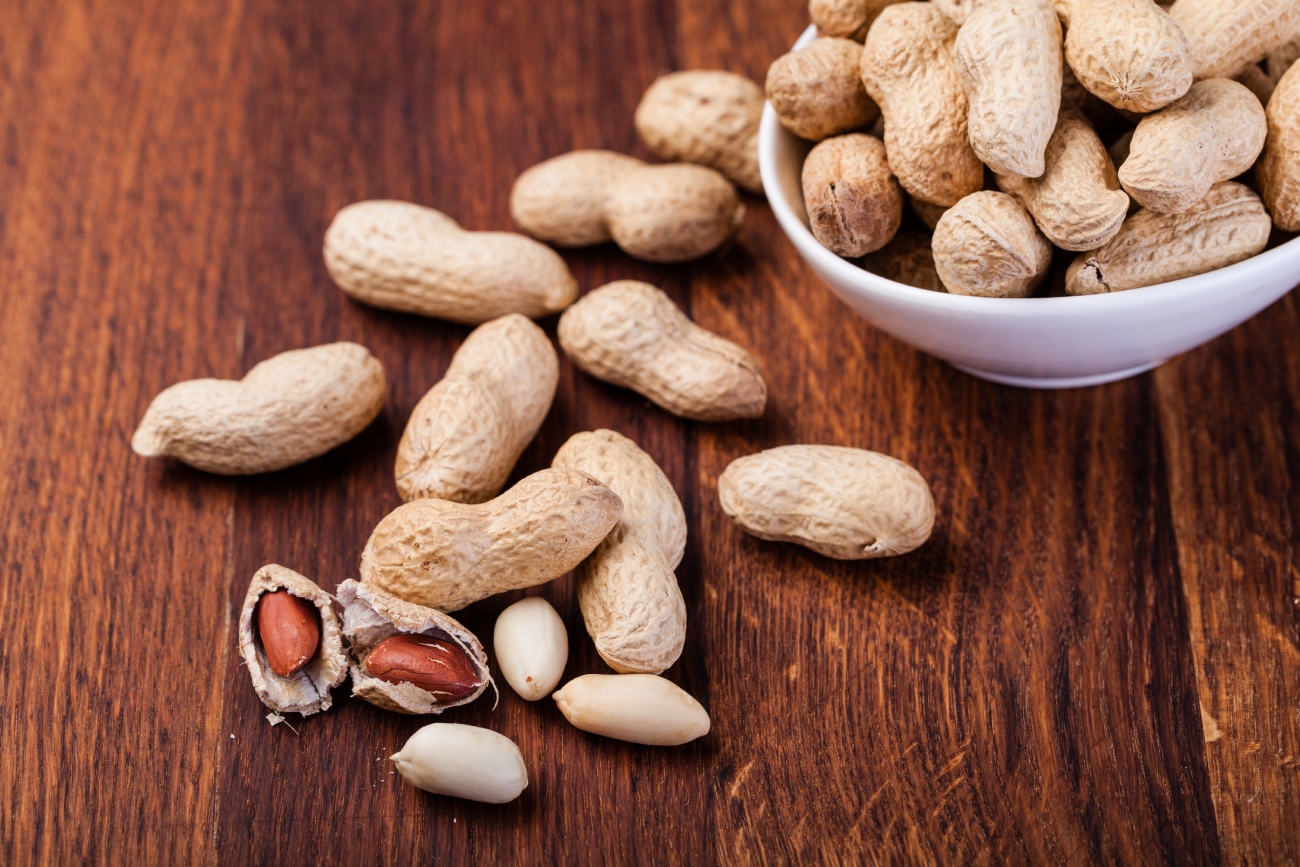 Peanuts isolated on a wooden table